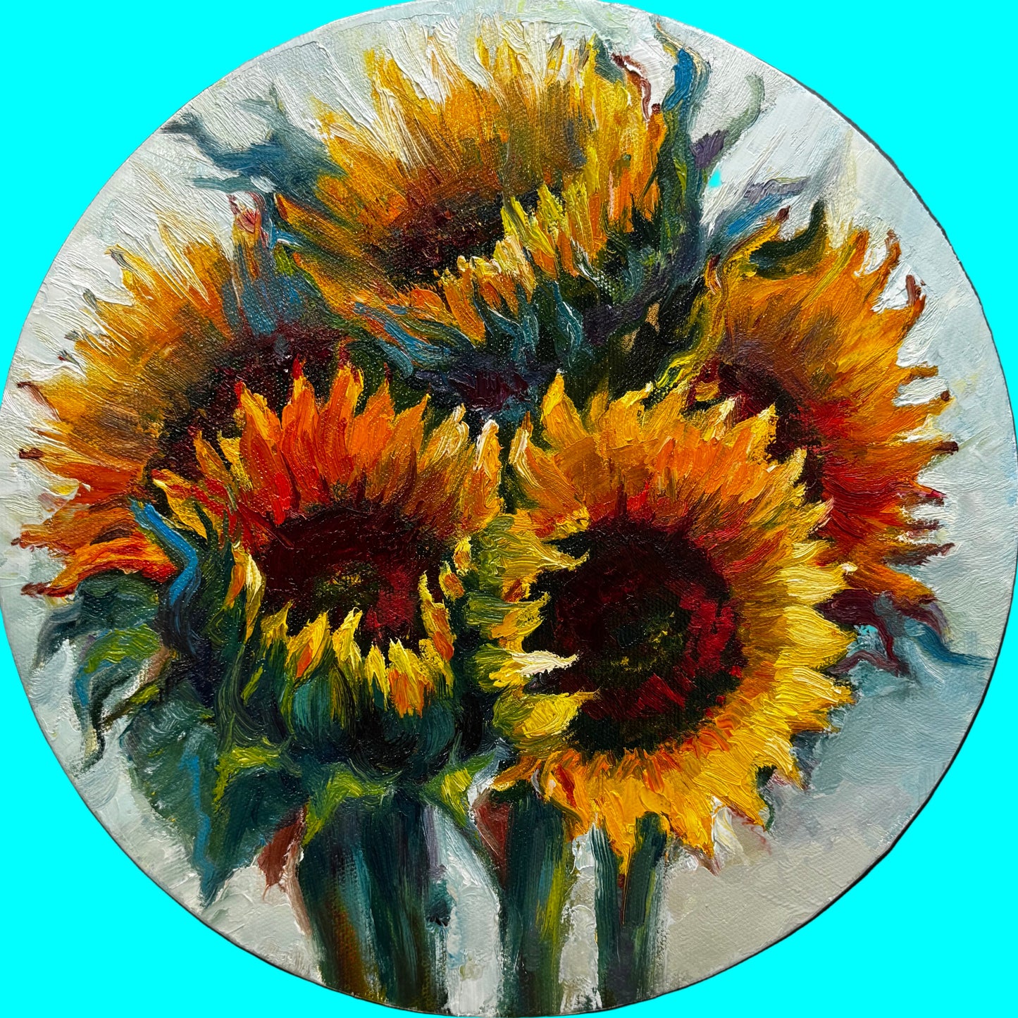 Painting of sunflowers on a round canvas with art supplies in the background